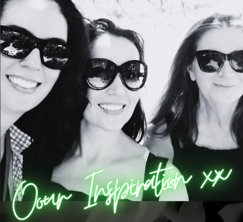 Two sisters sitting at a curated workspace surrounded by candles, homewares, and design samples—representing the heart of Hunted + Co.