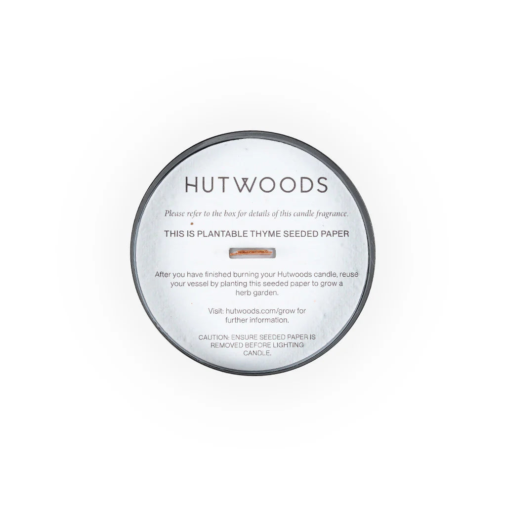 Hutwood candle in black container viewed form the top with the seeded paper ready for planting