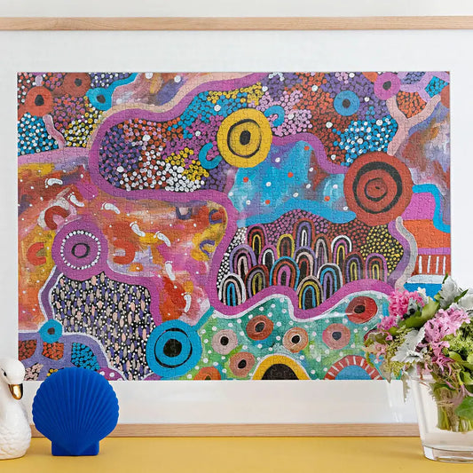 Framed Budgabulla puzzle featuring detailed illustration of a sacred Northern Territory site. Stunning!