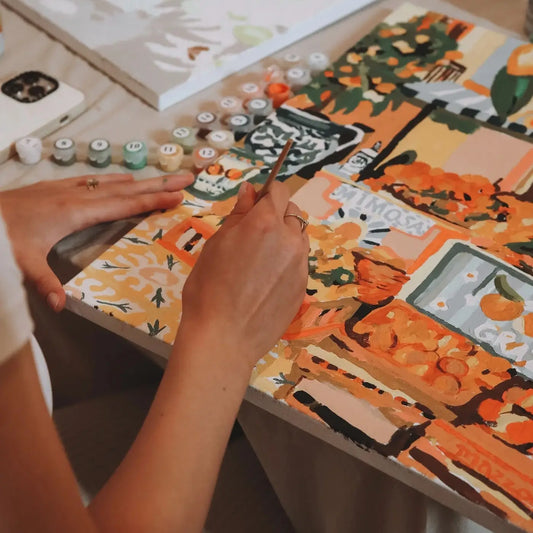 Artist painting the Palermo canvas using included brushes