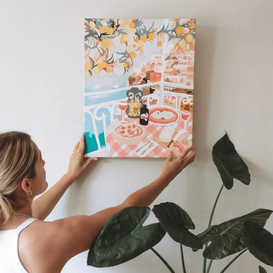 Framed Positano paint by numbers kit with Amalfi Coast scene going up on a wall.