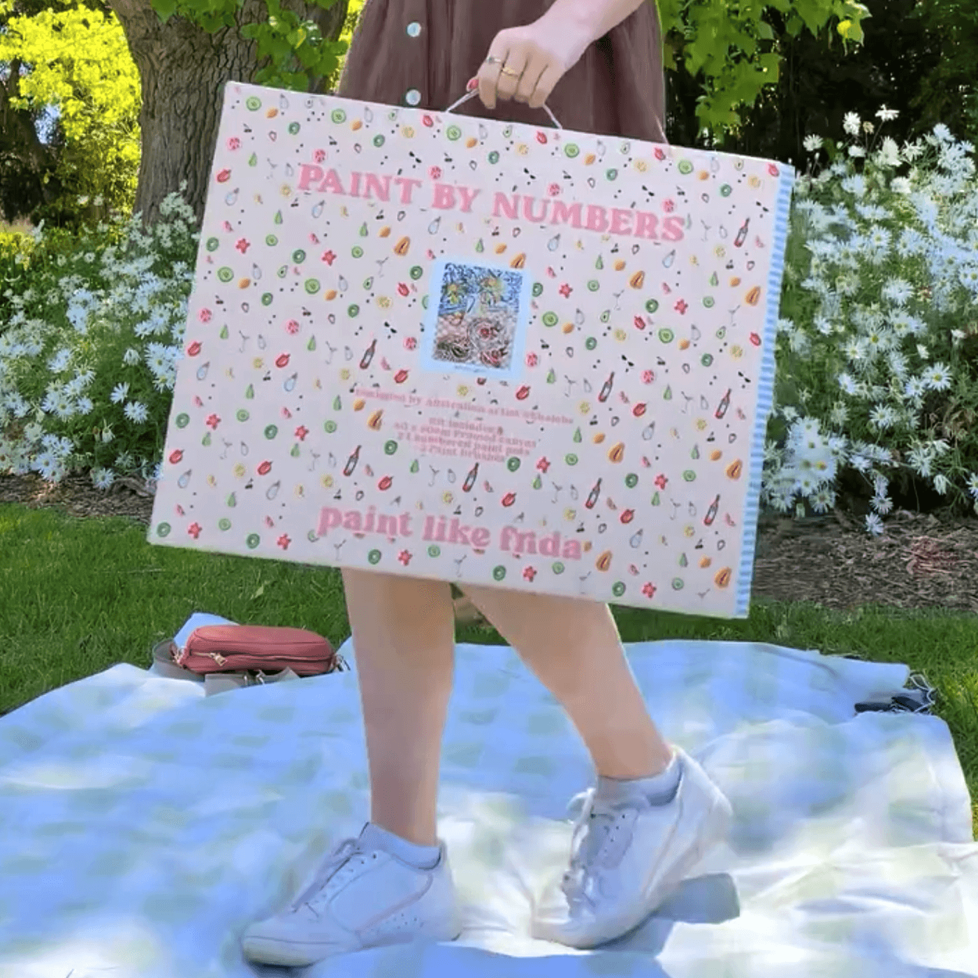 A Paint Like Frida kit ready to paint on a blankie on the grass.
