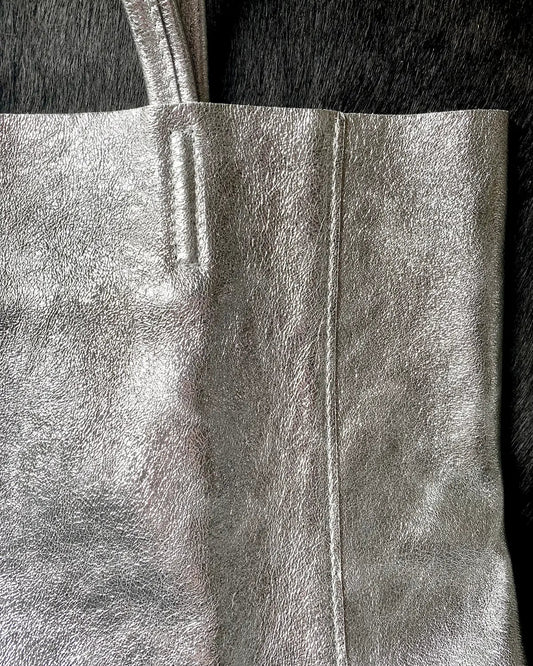 Close up detail of the Maison Fanli Large Tote in Metallic Silver highlighting the minimalist design, stitching and the texture of the leather. Gorgeous.
