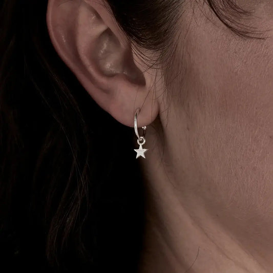 A model wearing a pair of Stolen Girlfriends Club Stolen Star Anchor Sleeper Earrings in sterling silver. So cute, chic and timeless. I love them.