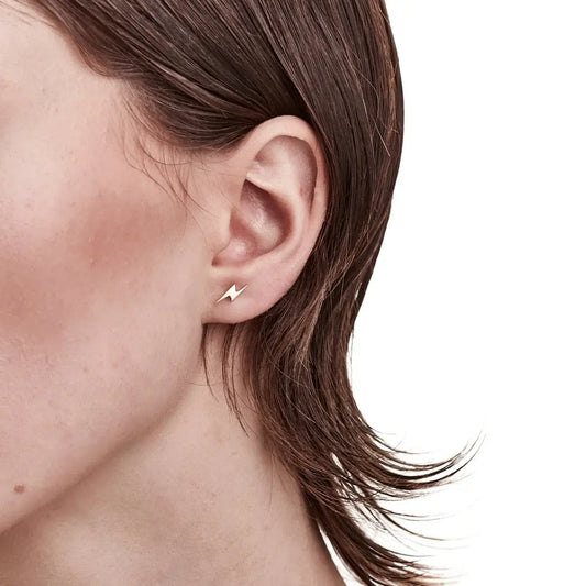 A model wearing the Gold I'll Be Lightning Earrings to give you an idea of scale and size. Perfect for wearing on their own or for stacking. Cute as.