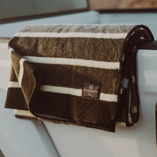 The Beyond Boarders Collective The Caminante Blanket is a stunning and versatile blanket that can go anywhere, like the side of a ute in this image. Beautiful, practical ethical and sustainable.