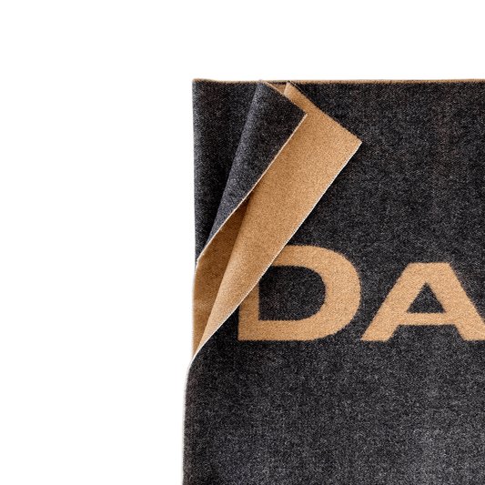 The Ferguson Wool Logo Blanket Scarf close up to highlight the texture and blunt edges. Gorgeous.