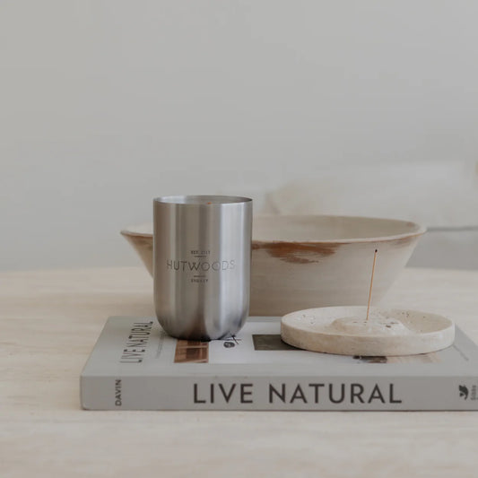 Hutwoods 350g/80 hour candle displayed on a marble tabletop