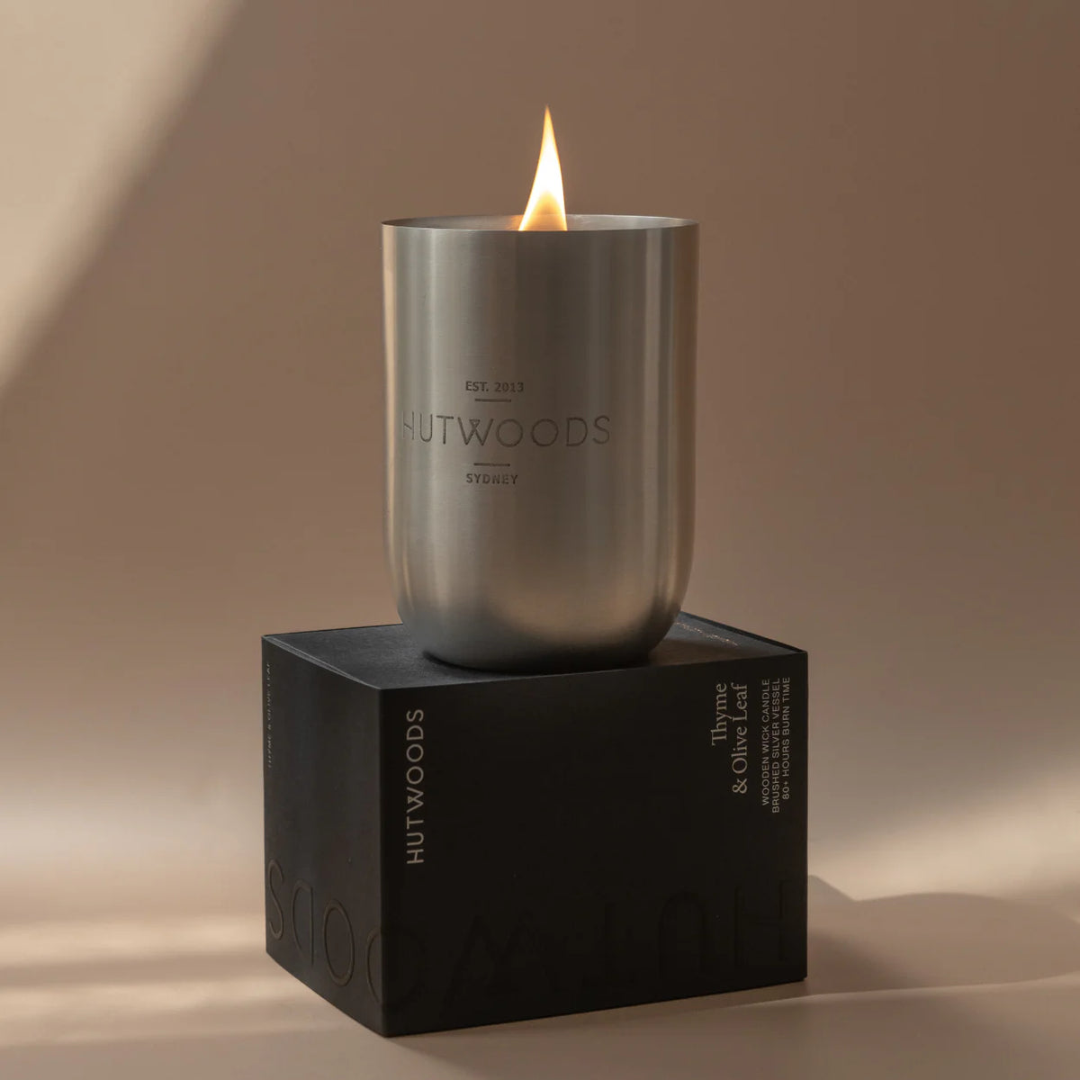Hutwoods Thyme & Olive Leaf Candle showcasing sleek, minimal, black packaging