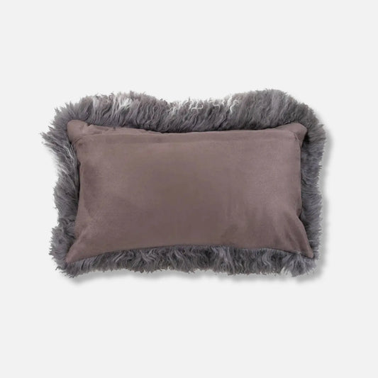 A rectangular lumbar pillow with a dusty mauve-grey suede-like centre and a shaggy grey faux-fur border, shown on a light grey background.
