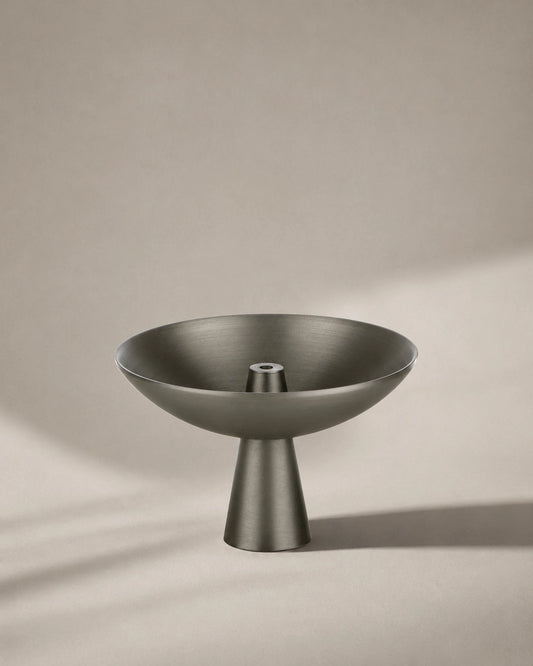 Alta Saturn incense holder in a black nickel finish with a modern pedestal design on a neutral background.