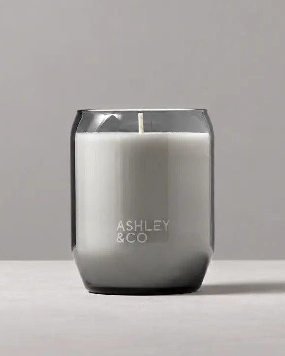 Grey glass soy candle set against minimal grey toned background