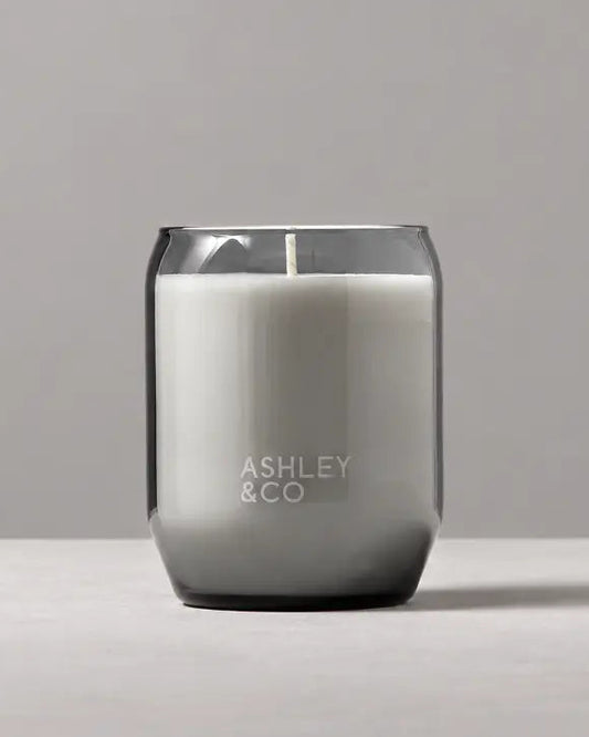 Grey glass soy candle set against minimal grey toned background