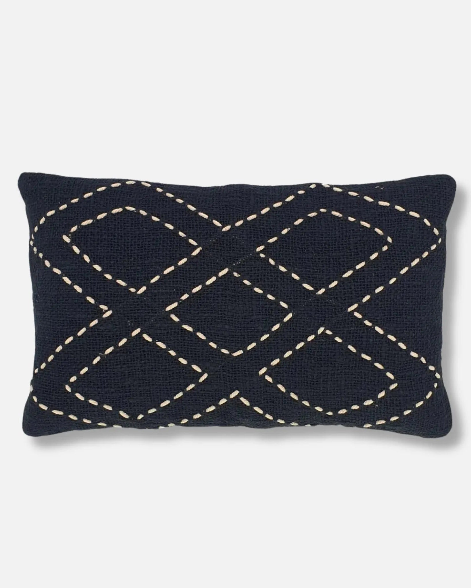Black raw linen lumbar cushion with hand-stitched white diamond pattern on a light grey background.