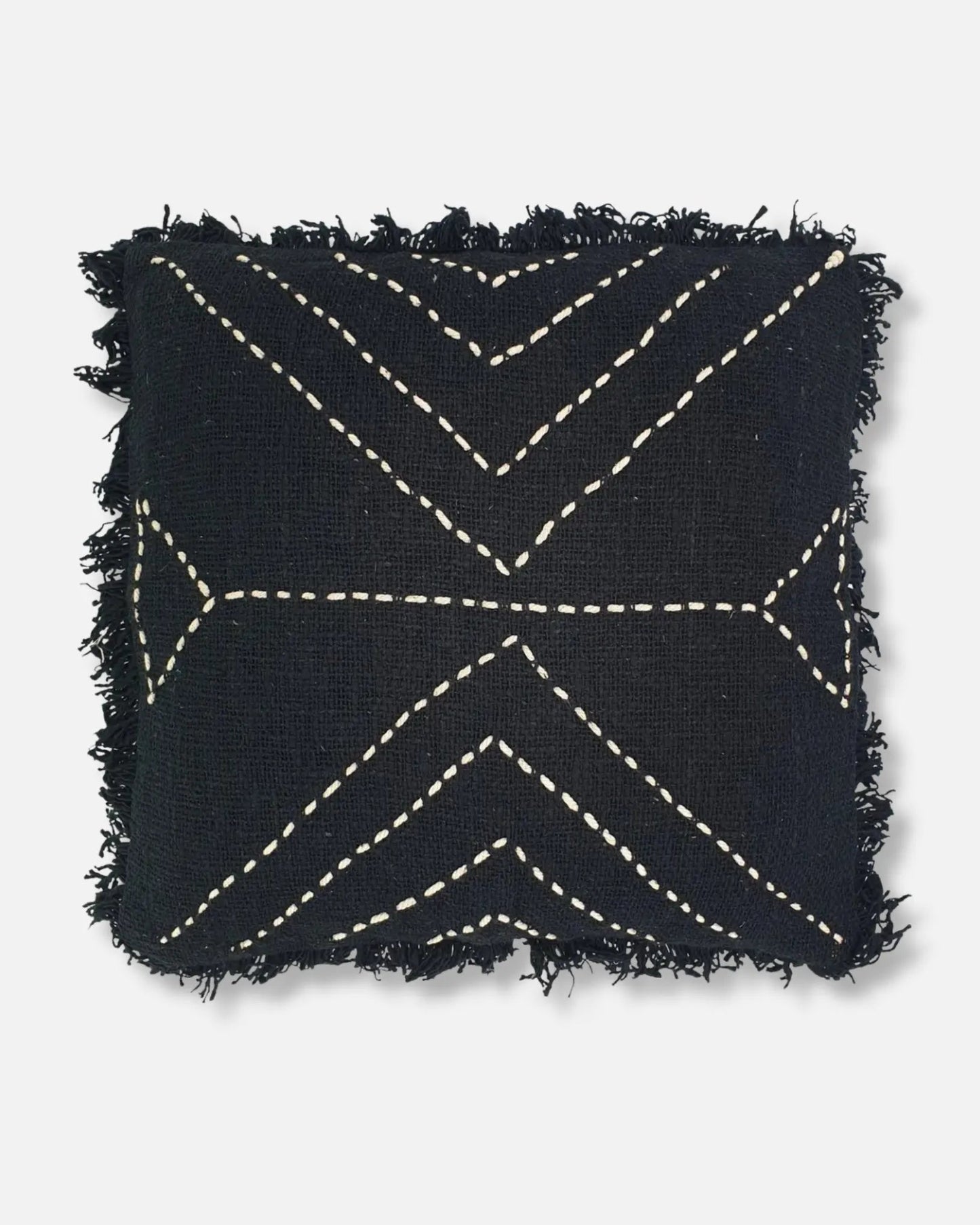 A square black throw pillow with frayed edges and cream-colored geometric stitched patterns, shown against a light gray background.
