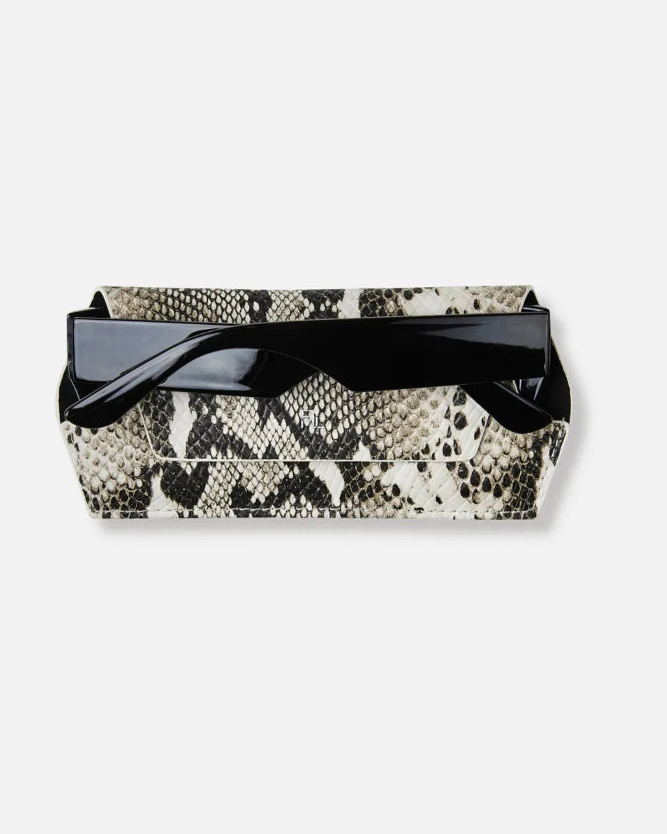 A rectangular clutch bag with a black and beige snakeskin pattern, featuring a glossy black top flap and strap, set against a plain light gray background.