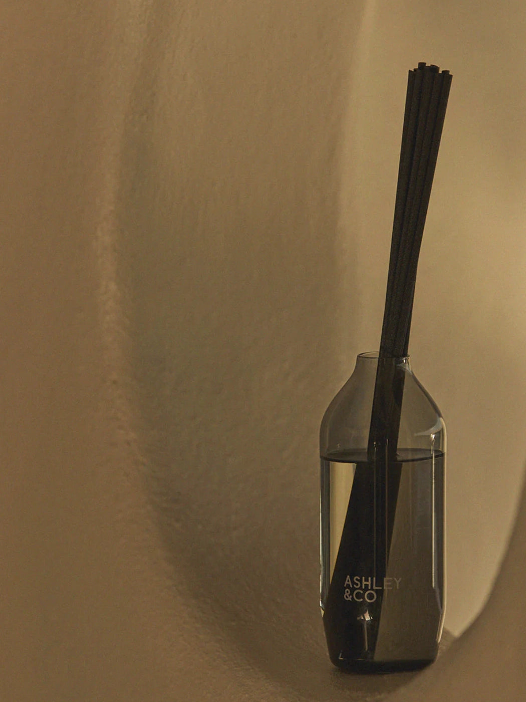 Ashley & Co Tui & Kahili Home Perfume Reed Diffuser in a wall alcove looking very stylish