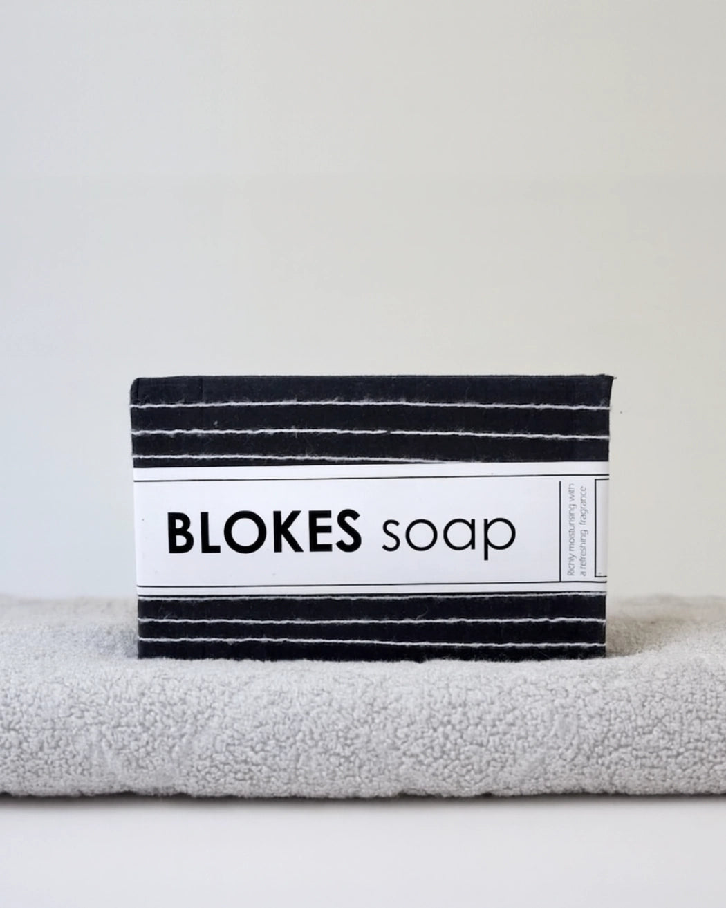 Blokes Soap on a light grey towel on a light background