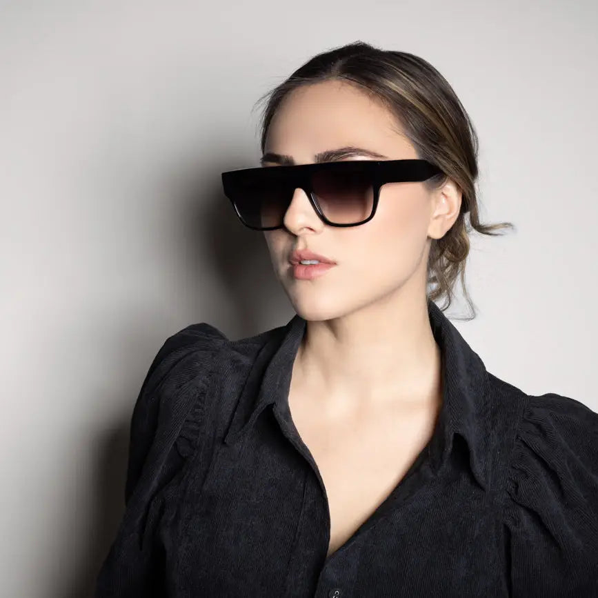 Retro D-frame sunglasses with faded lenses as worn by a model