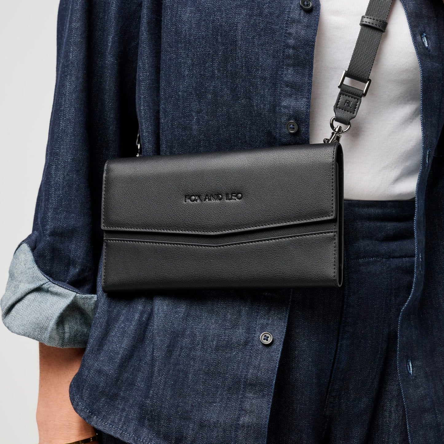 A person wearing The Traveller with it's removable strap. Can be work crossbody or over the shoulder. 