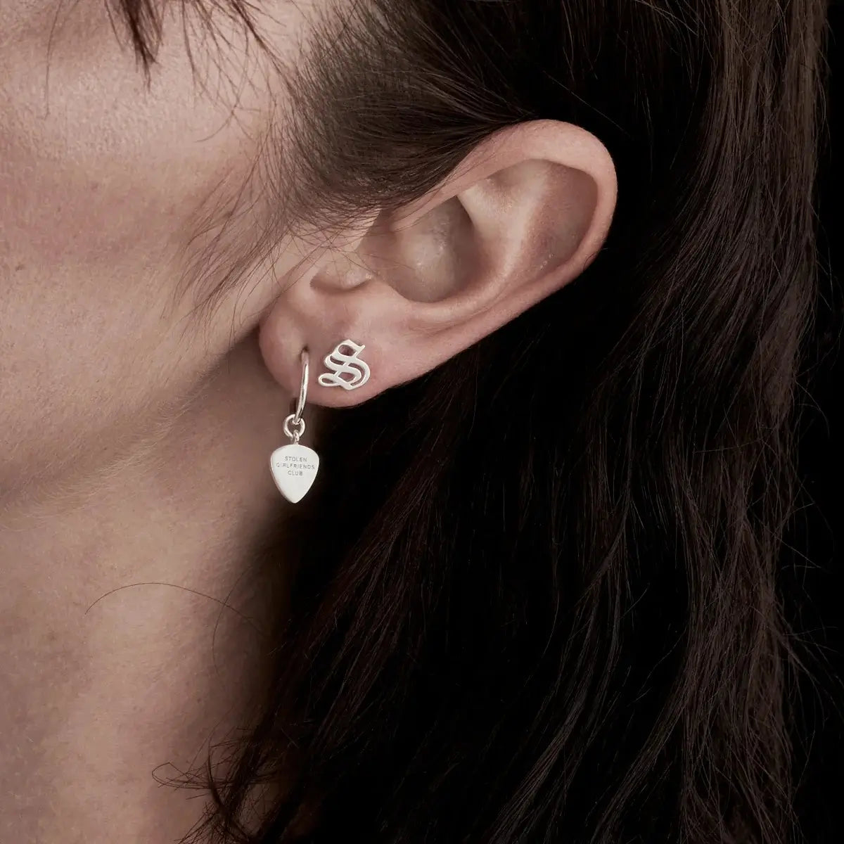 Close up image of the Stolen Girlfriends club Guitar Pic Earrings in Sterling Silver.