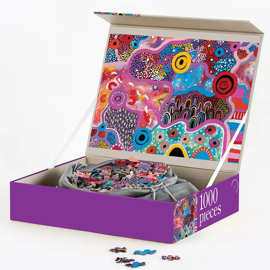 Budgabulla 1000-piece puzzle box showcasing Mulganai’s vibrant Indigenous artwork.