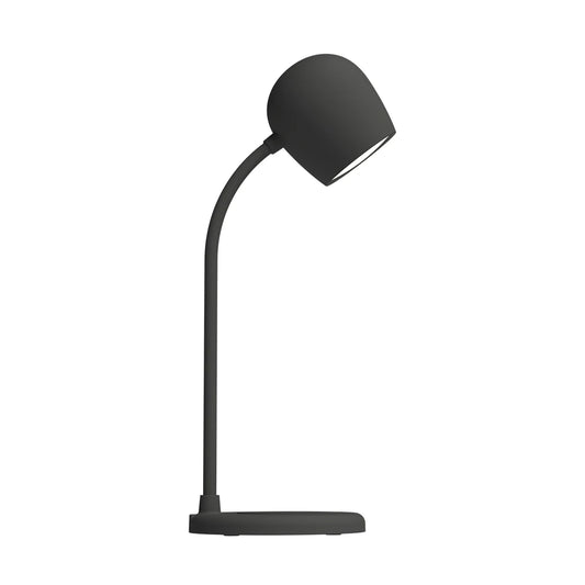 Ellie multifunctional lamp on a bedside table emitting warm light