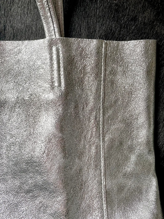 Close up detail of the Maison Fanli Large Tote in Metallic Silver highlighting the minimalist design, stitching and the texture of the leather. Gorgeous. 