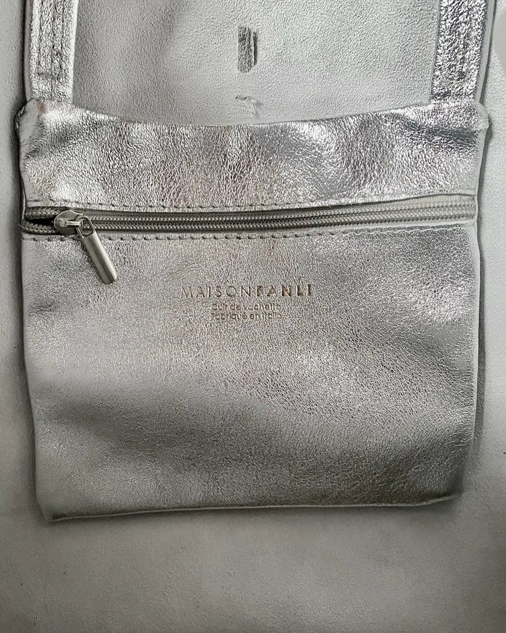 Internal pocket of the silver metallic Maison Fanli large tote bag to keep small things secure and easy to find.