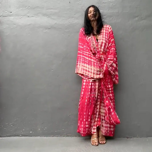 Hand-dyed pink and white bamboo kimono robe with matching travel bag, flat-lay.