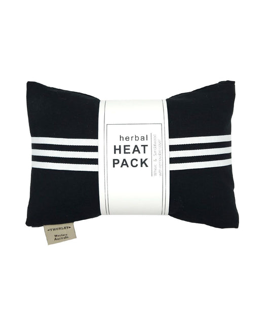 A black heat pack with a triple white stripe across the middle and a white label saying 'herbal HEAT PACK' on it.