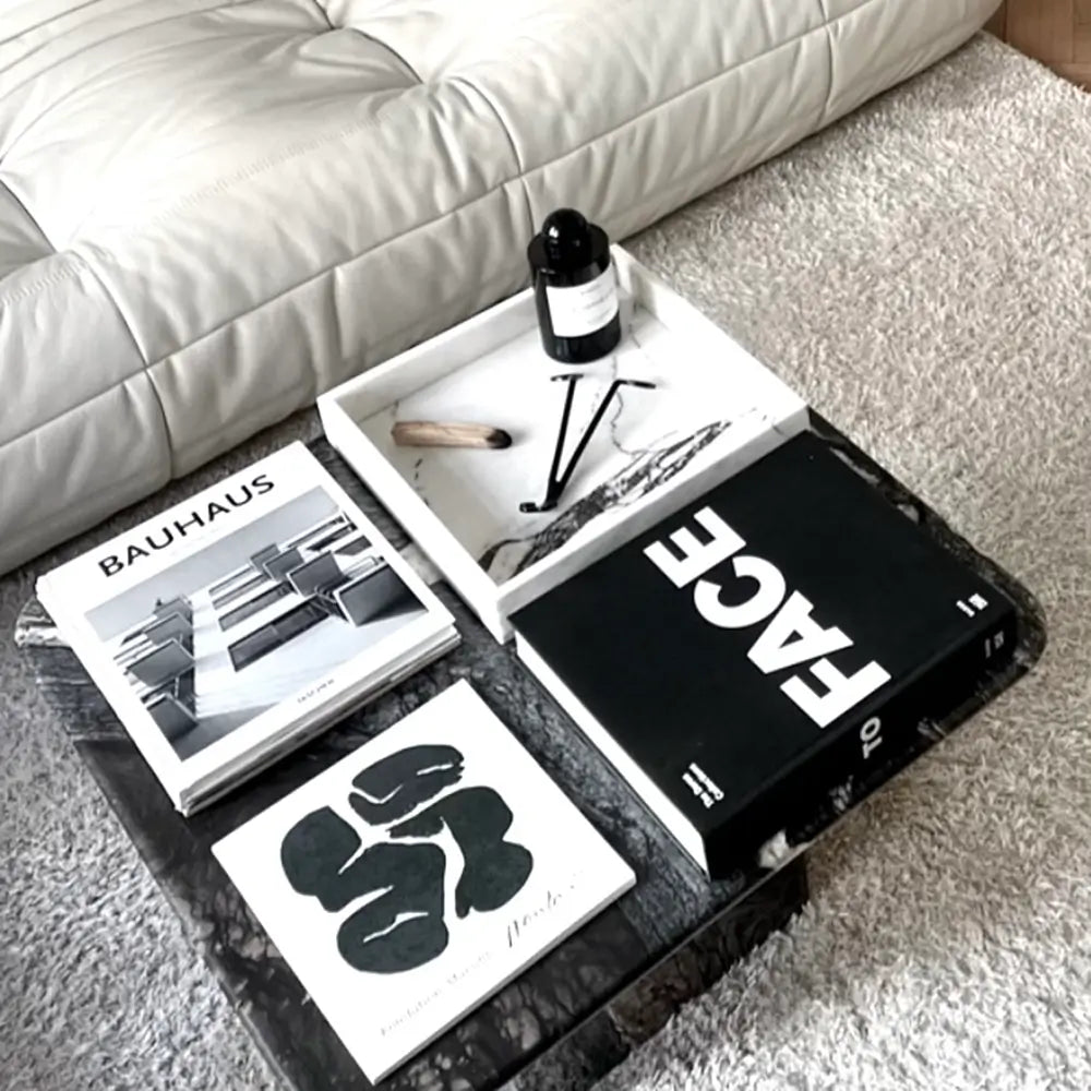 White marble Majsa tray - a versatile Scandinavian décor piece placed on a coffee table with a bunch of gorgeous coffee table books.