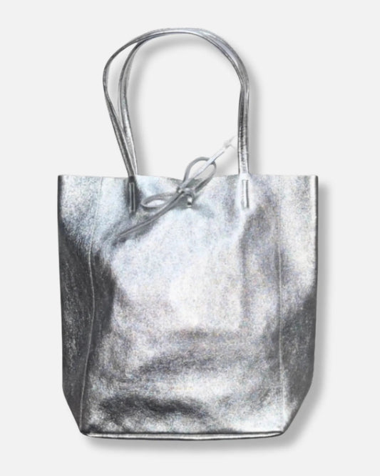 A metallic silver canvas tote bag with dual top handles and a small silver drawstring detail at the top, shown against a light gray background.