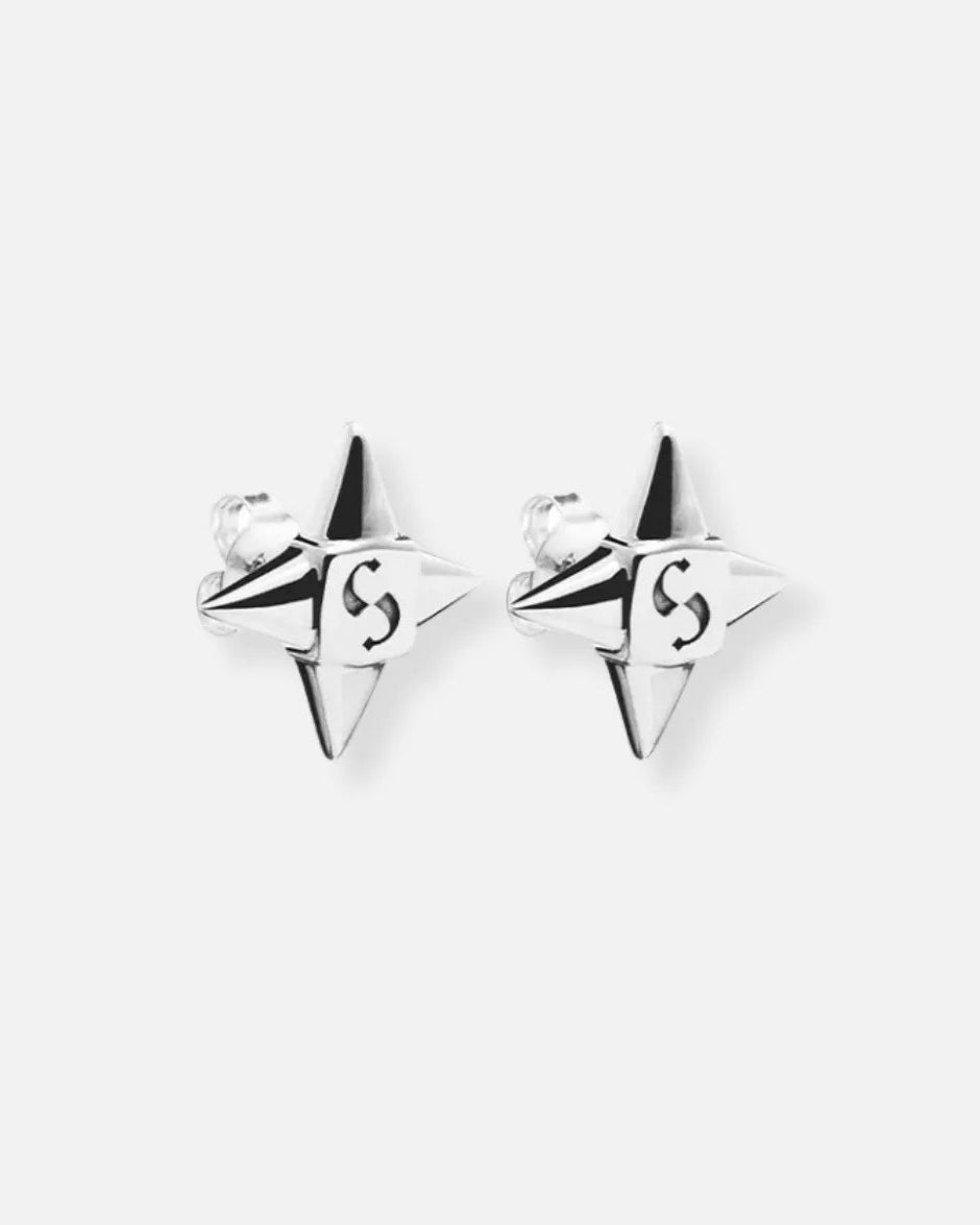A pair of silver-toned bow stud earrings adorned with small clear stones and featuring a dangling white pearl below each bow, set against a plain white background.