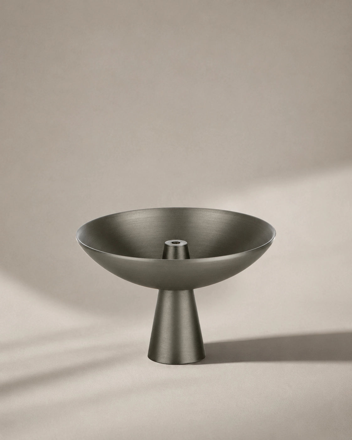 Alta Saturn incense holder in a black nickel finish with a modern pedestal design on a neutral background.
