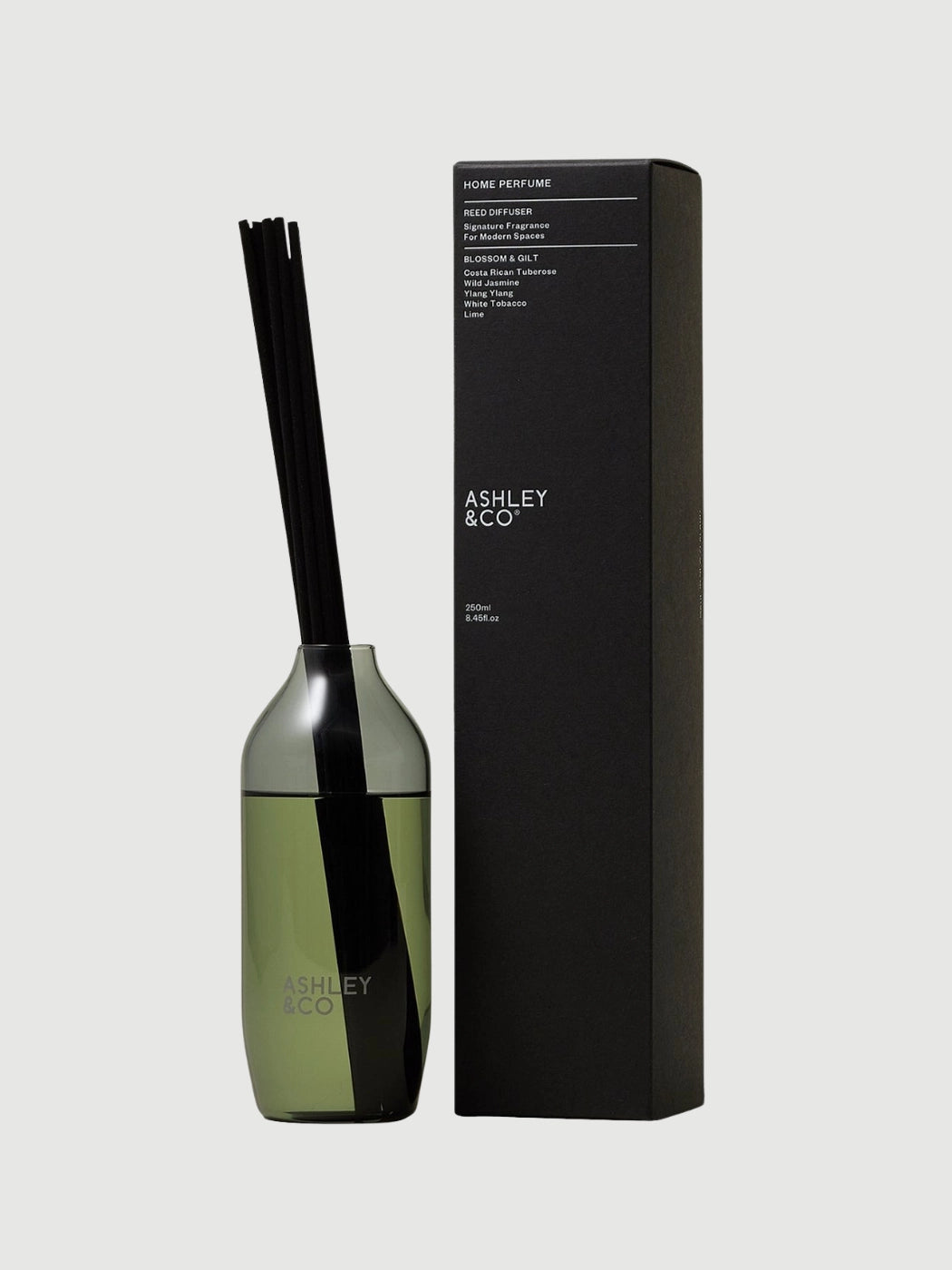 Blossom and Gilt home reed diffuser in smoky grey glass vessel by Ashley and Co