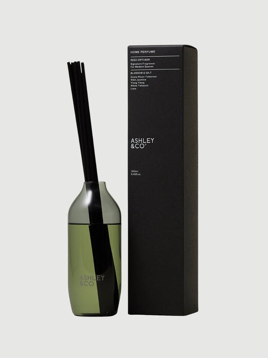 Blossom and Gilt home reed diffuser in smoky grey glass vessel by Ashley and Co