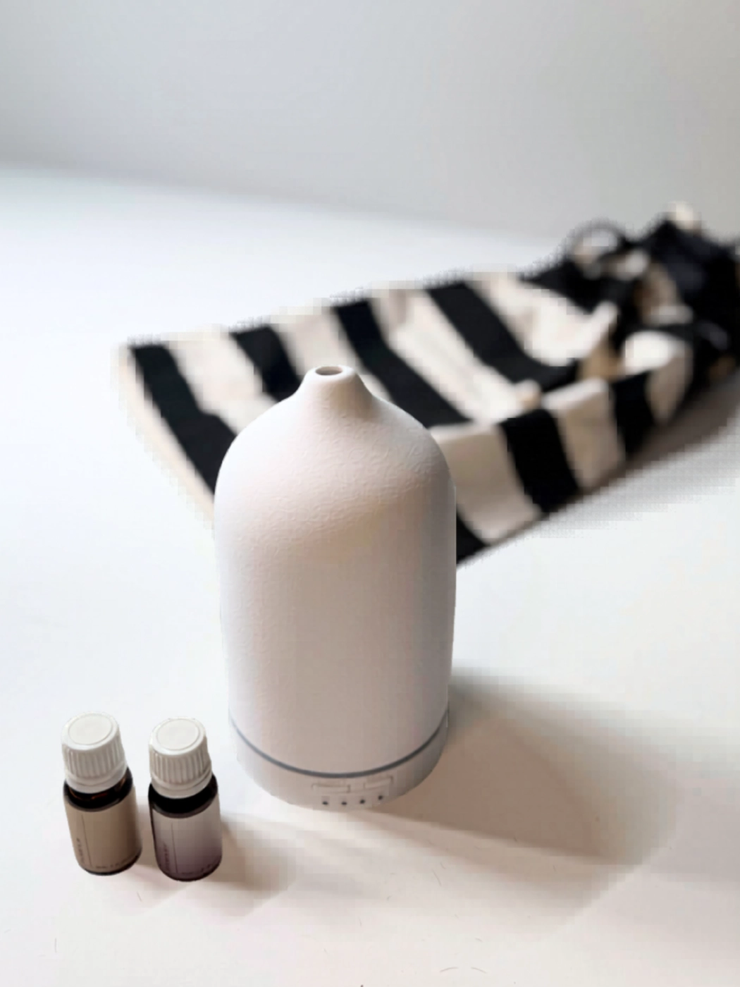 Ceramic diffuser with essential oils styled for home relaxation and calm atmosphere