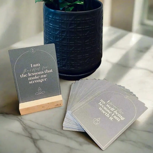 Set of motivational cards available from Hunted + Co. on a marble table with a potted plant in the background