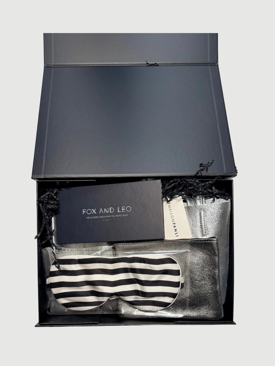 Open Luxe Wanderer gift box showing leather tote, silk sleep mask, metallic pouch and glasses case inside