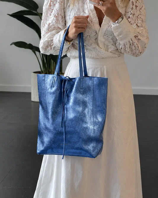 Maison Fanli metallic blue leather tote bag, crafted from soft Italian calfskin. A lightweight, foldable everyday carryall designed in France and made in Italy.