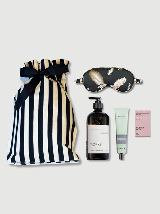 Luxury body and sleep gift set with WØRKS saltbush body wash, body balm, Ashley and Co soap, satin sleep mask and striped reusable gift bag