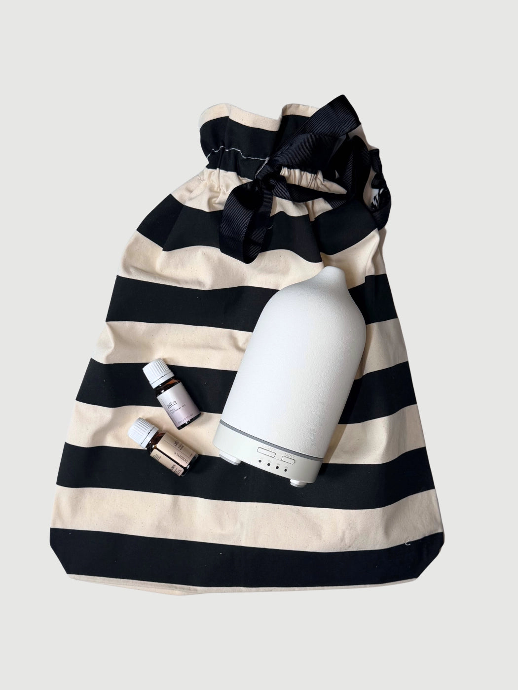 Wellness gift set with ceramic diffuser lavender essential oil and striped reusable gift bag