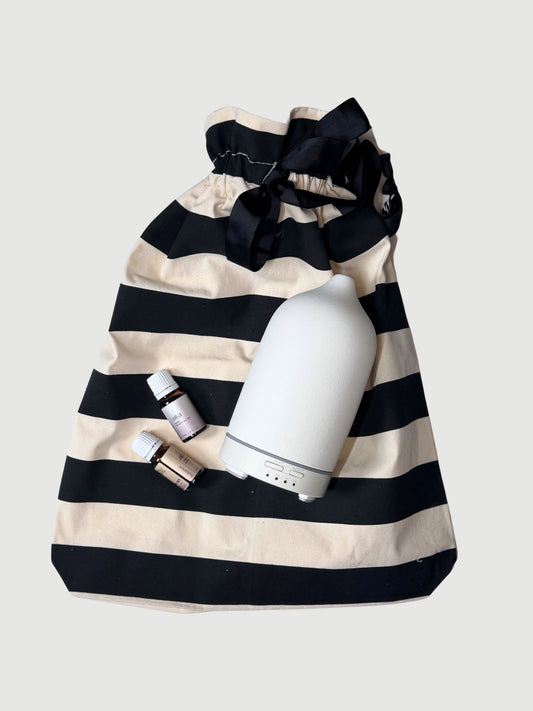 Wellness gift set with ceramic diffuser lavender essential oil and striped reusable gift bag